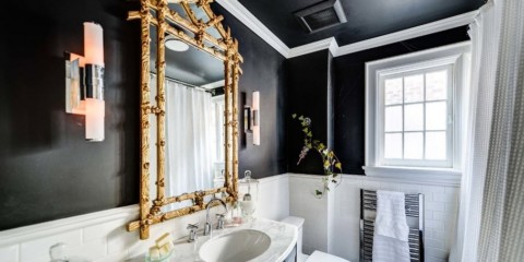Black and white bathroom with a golden accent