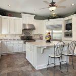 Island design of white kitchen in classic country style