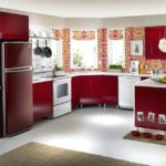Refrigerator in the interior of the kitchen in red colors
