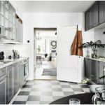 The gray palette of the kitchen in metallic tones is diluted with white
