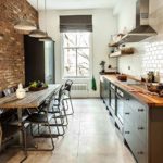 The interior of an elongated loft style kitchen
