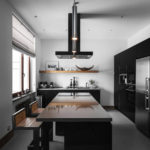 Kitchen with black furniture in a private house