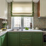 Kitchen in white and green tones with tiles with an interesting ornament