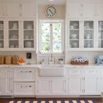 Provencal kitchen with white glass cabinets with beautiful dishes