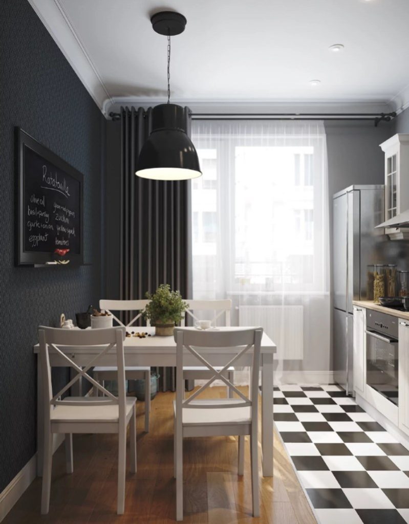 Mesa de comedor luminosa frente a una pared negra en una cocina cuadrada de 8