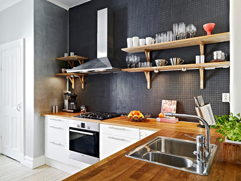 Cooker hood on a black wall with shelves