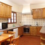 U-shaped kitchen with tiled wall