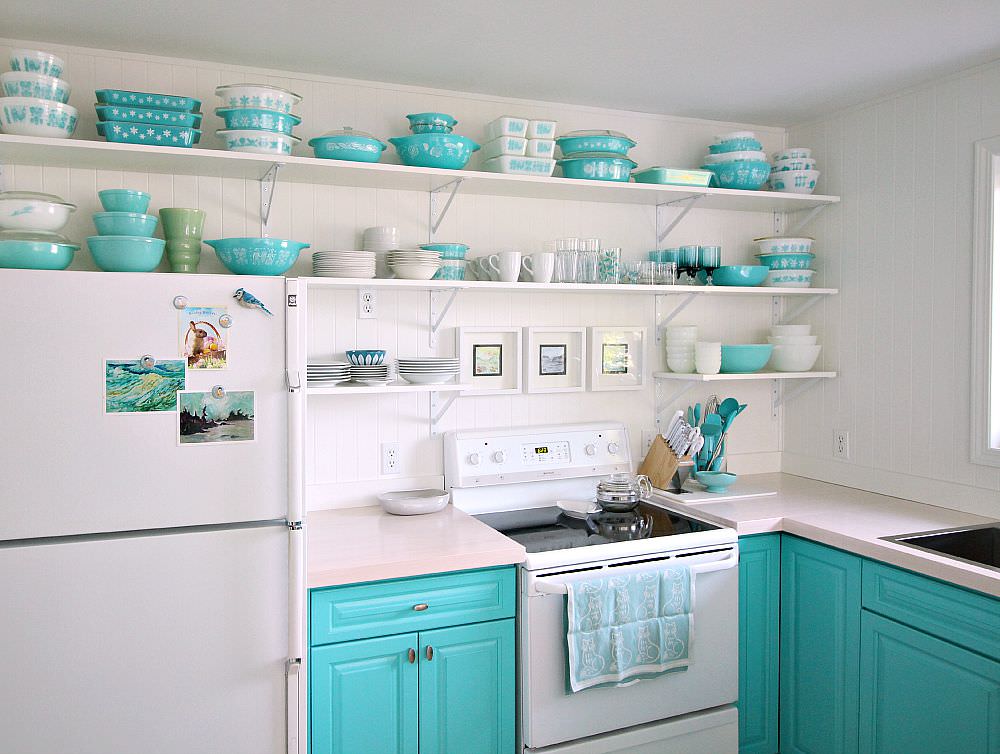 Turquoise dishes on white kitchen shelves
