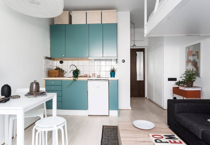 Scandinavian-style kitchen interior with turquoise furniture