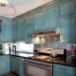 Aged surfaces in a turquoise blue kitchen unit