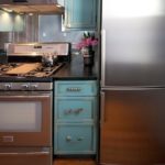 Household appliances in a turquoise-colored kitchen
