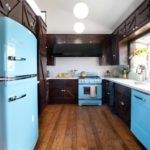 Black kitchen with turquoise refrigerator