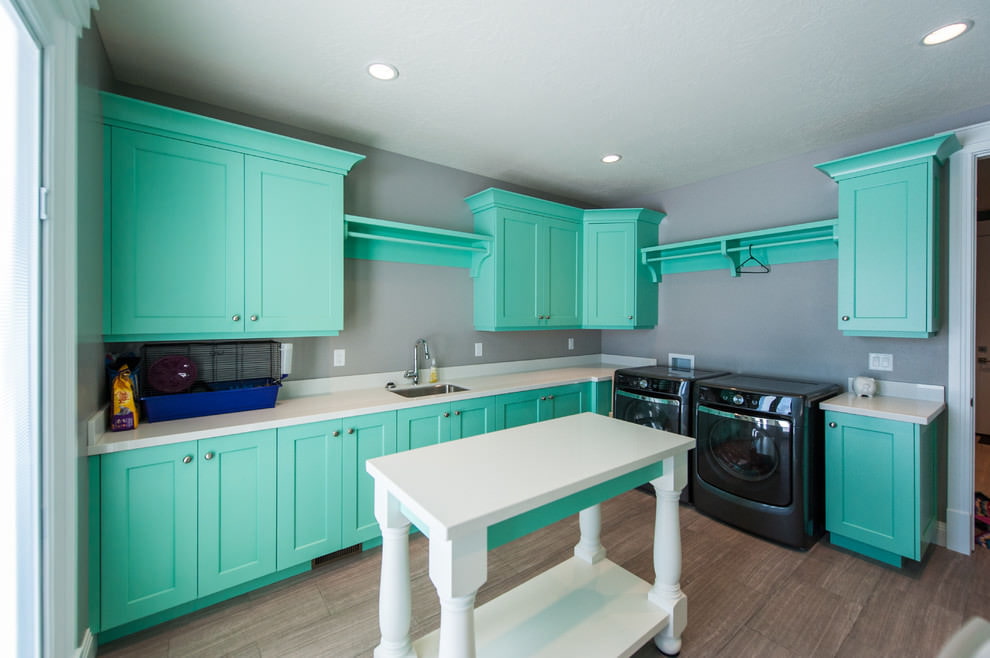 Mint-colored wooden furniture in the kitchen of a private house