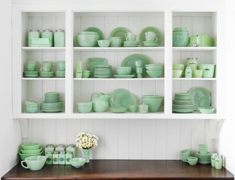 Mint dishes on open kitchen shelves