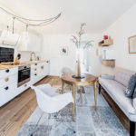 Long gray sofa for a snow-white kitchen