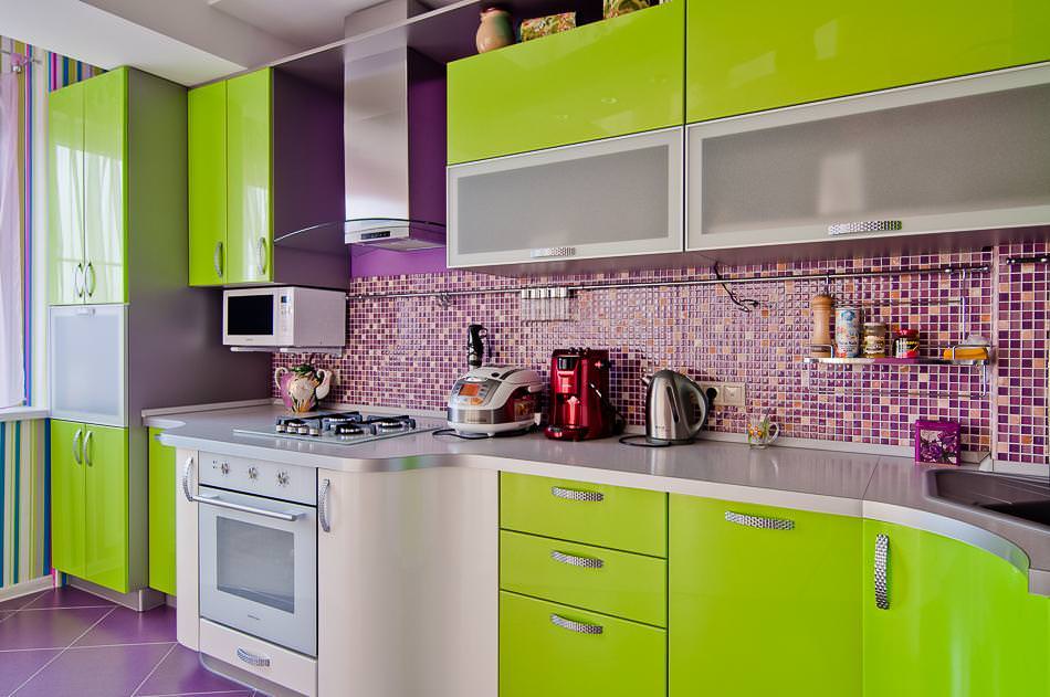 Glossy surfaces in a light green kitchen