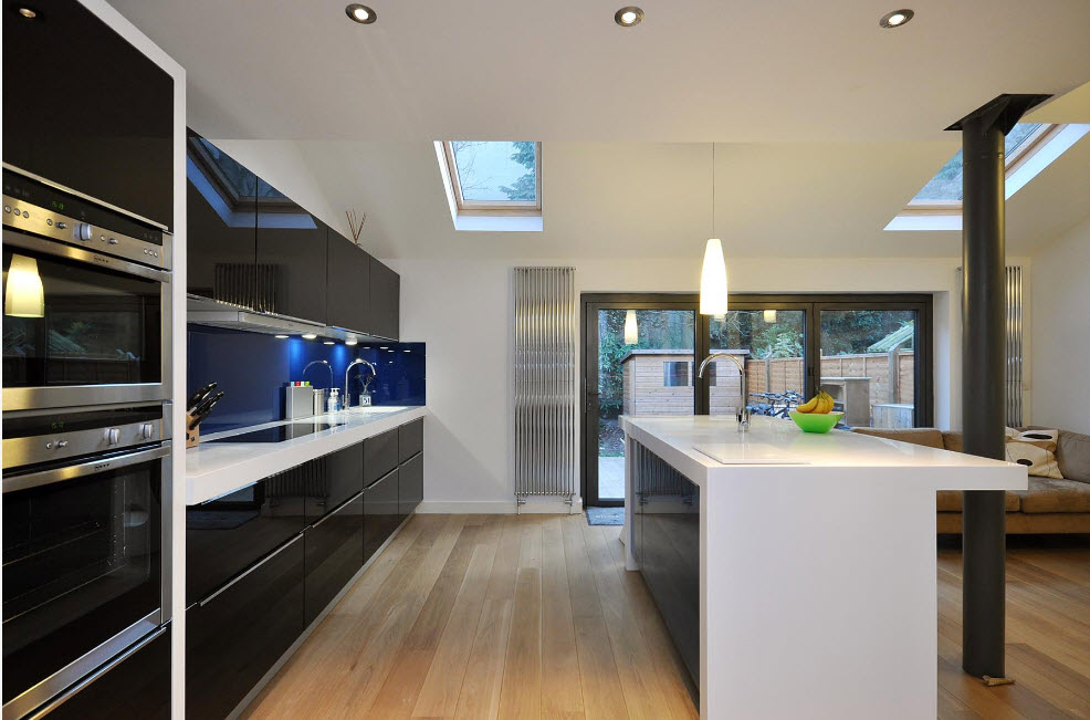 Black linear kitchen and white kitchen island