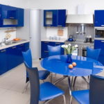 Bucătărie cu un set albastru, o masă rotundă albastră și scaune