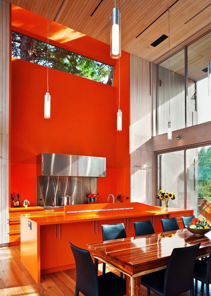 Orange vägg i köket med ett panoramafönster