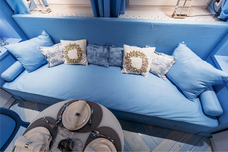 Upholstered sofa with blue fabric upholstery
