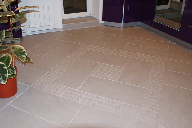 Large-format ceramic tile floor with small inserts