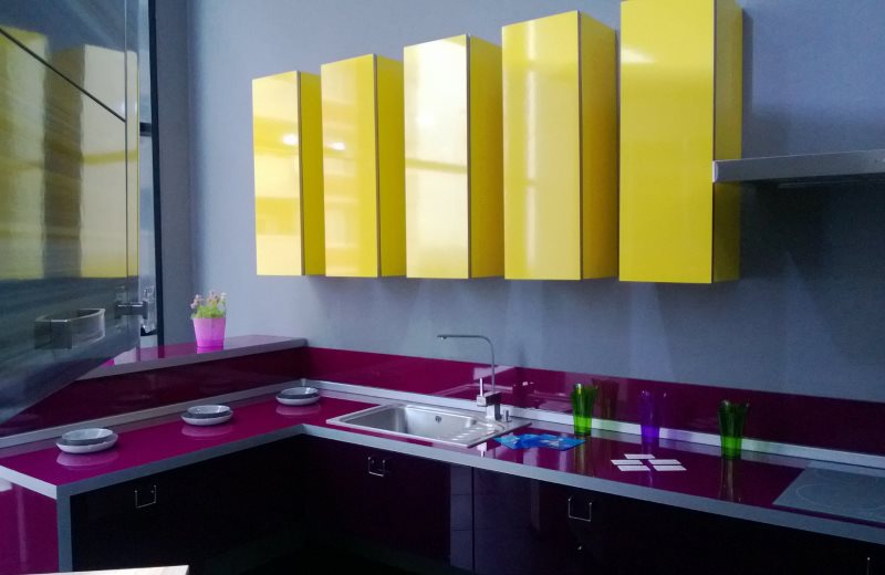 Yellow hanging cabinets over eggplant side tables