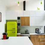 Green fridge in a white kitchen