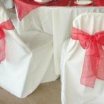Pink bows on the white backs of chairs