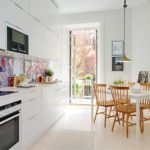 White kitchen with door to the balcony