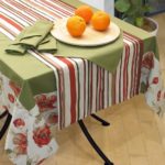 Green napkins on a striped tablecloth