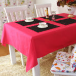 Black napkins for dishes on a red tablecloth