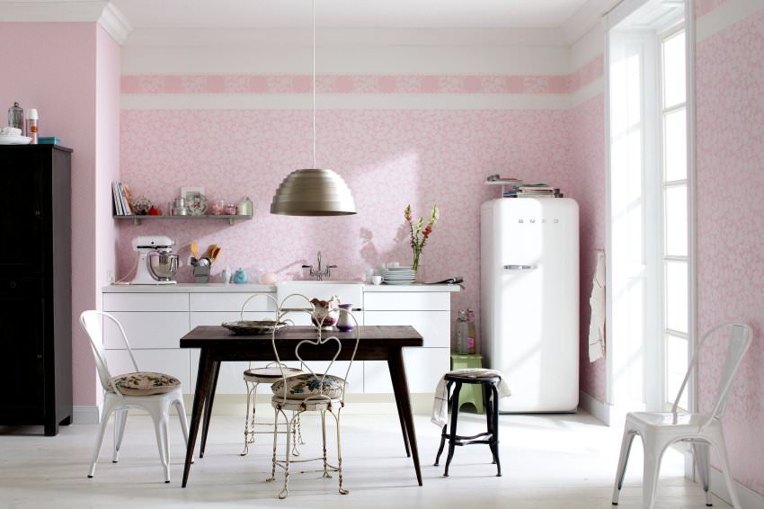 White refrigerator on a pink wall background