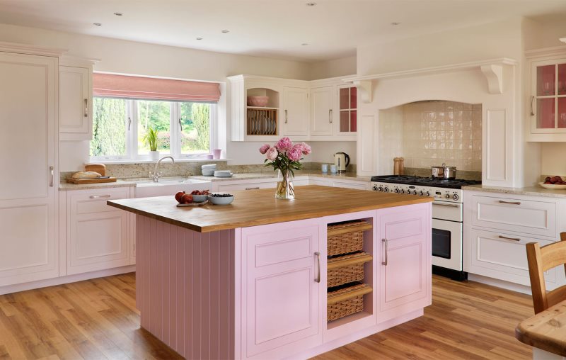 Wooden island kitchen top with pink facades