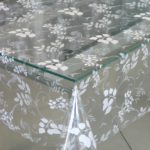 Transparent tablecloth-oilcloth on a glass countertop