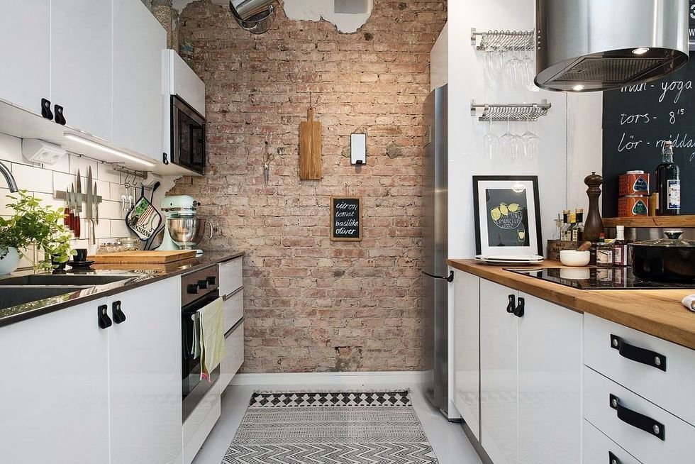 White kitchen in a small area in the loft style