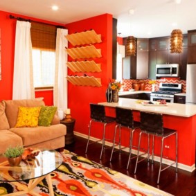 Red color in the interior of the kitchen-living room