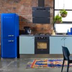 Blue refrigerator on brick wall background