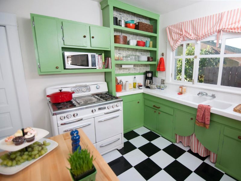Green facades of the L-shaped kitchen in retro style
