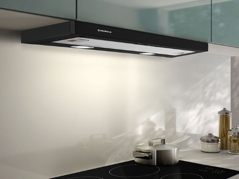 Built-in thin hood in the kitchen with induction hob