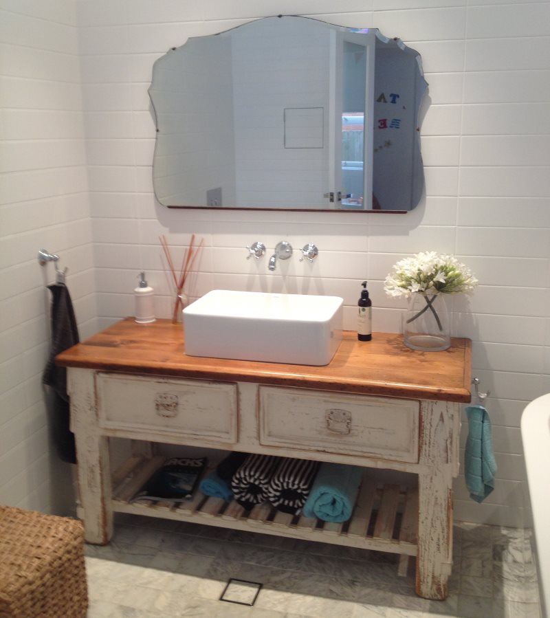 White sink on an old pedestal with shabby legs