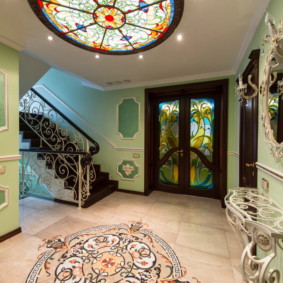 Stained glass in the interior of the hallway with stairs