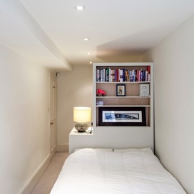 Narrow bedroom with white walls