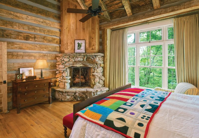Corner fireplace in a country style bedroom