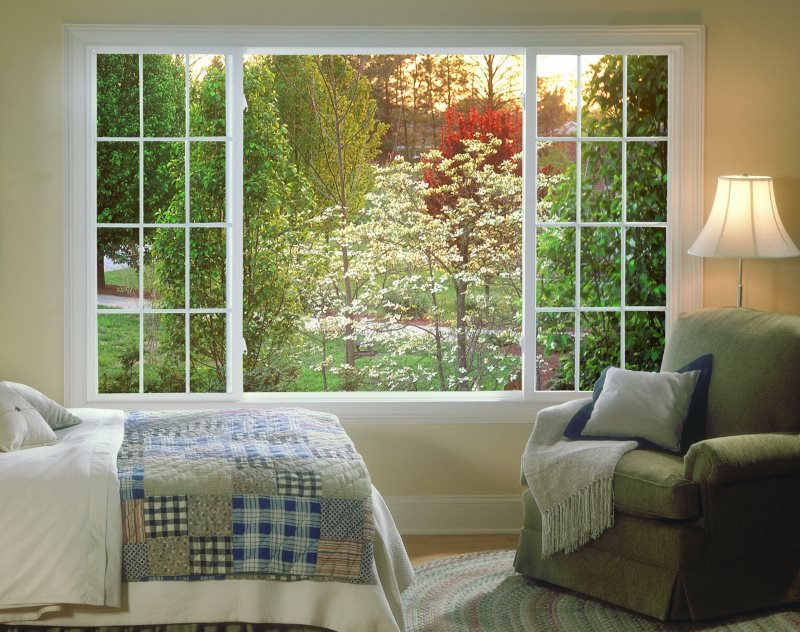 Wall mural with landscape in the fake window of a bedroom