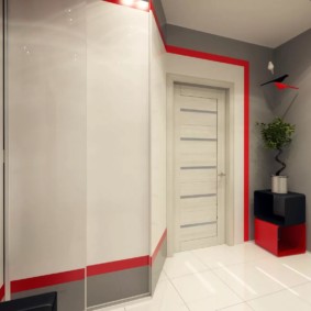 Red accents in the gray and white hallway