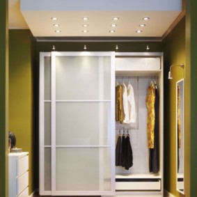 Women's clothing in a closet with sliding doors
