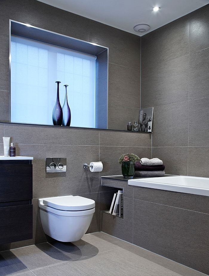 Gray tile in the bathroom with a hinged toilet