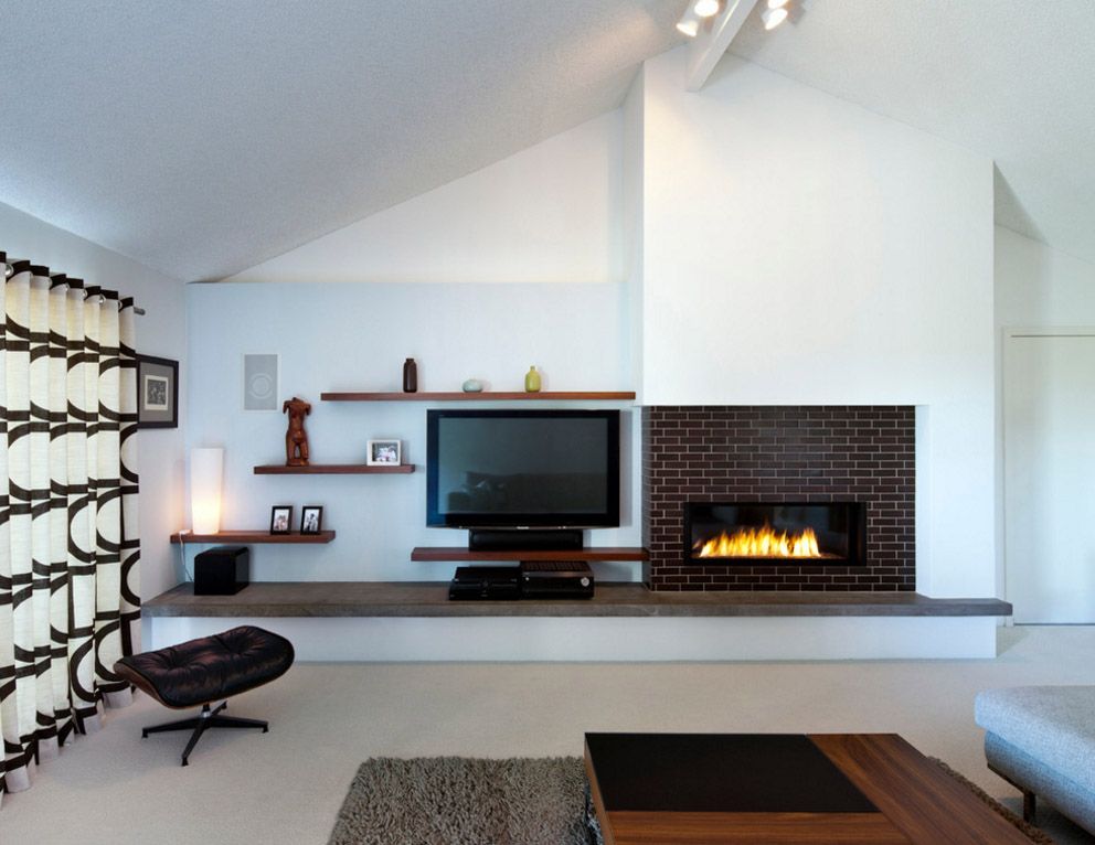 White wall of living room with fireplace and TV