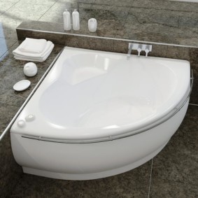 Small bathtub on a gray floor