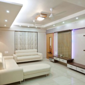 Upholstered white furniture in the hall of a two-room apartment